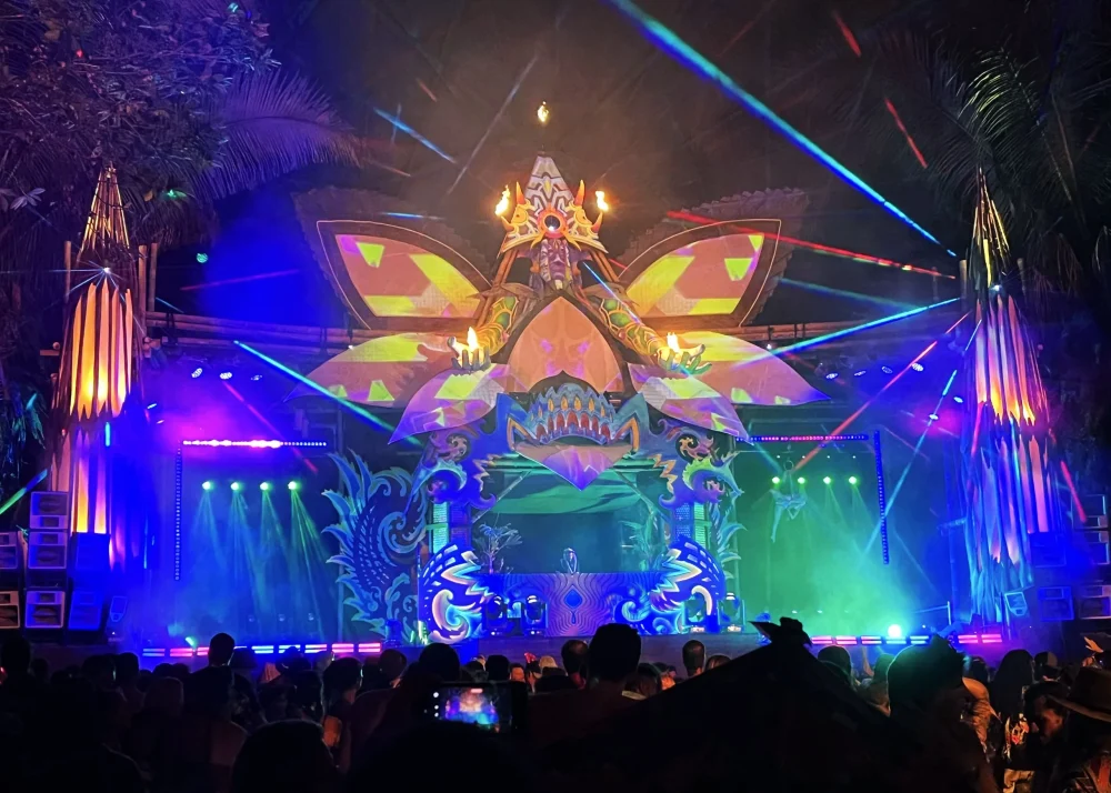 Envision Is Beautiful Because It Is Complicated 10 Nighttime Envision Festival stage scene with lights and people gathered in front of the performance area.