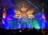 Nighttime Envision Festival stage scene with lights and people gathered in front of the performance area.