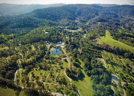 Aerial view of Woodfordia showing roads, wooded camping areas, open fields and Lake Gkula.