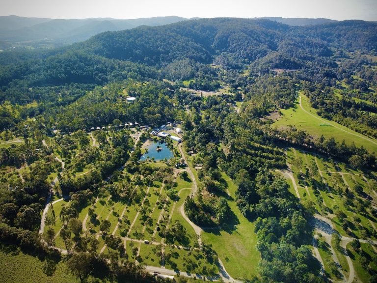 Aerial view of Woodfordia showing roads, wooded camping areas, open fields and Lake Gkula.