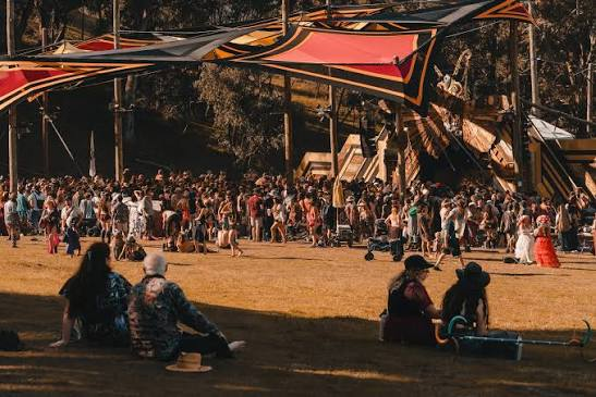 Dragon Dreaming '26 Inspo Guide 2 Wide view of a crowd and patterned stage canopy