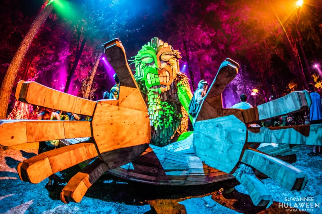 Suwannee Hulaween '26 Inspo Guide 3 A large illuminated bird-like installation among trees