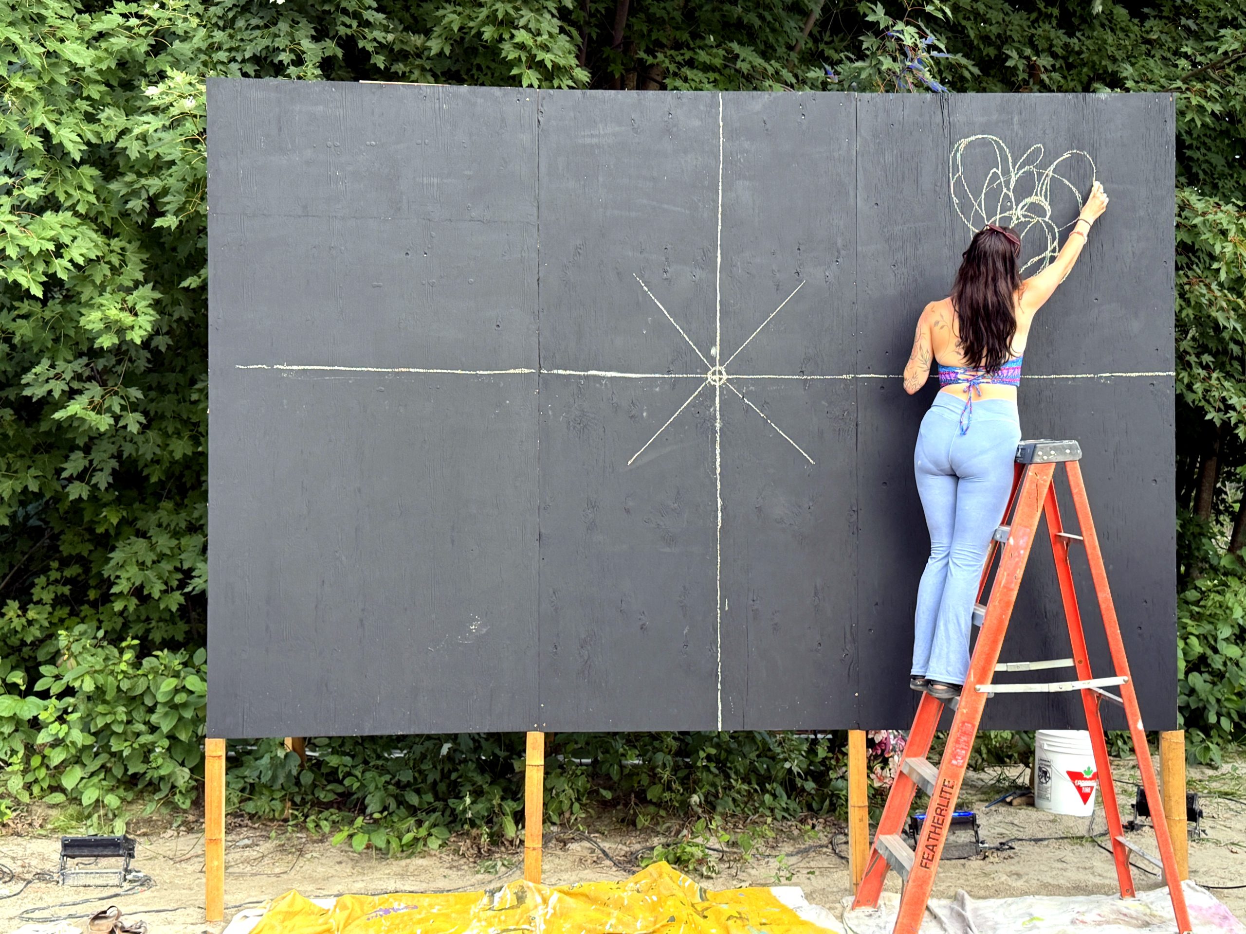 A World Worth Making 15 An artist draws on an outdoor art wall at Sonic Springs